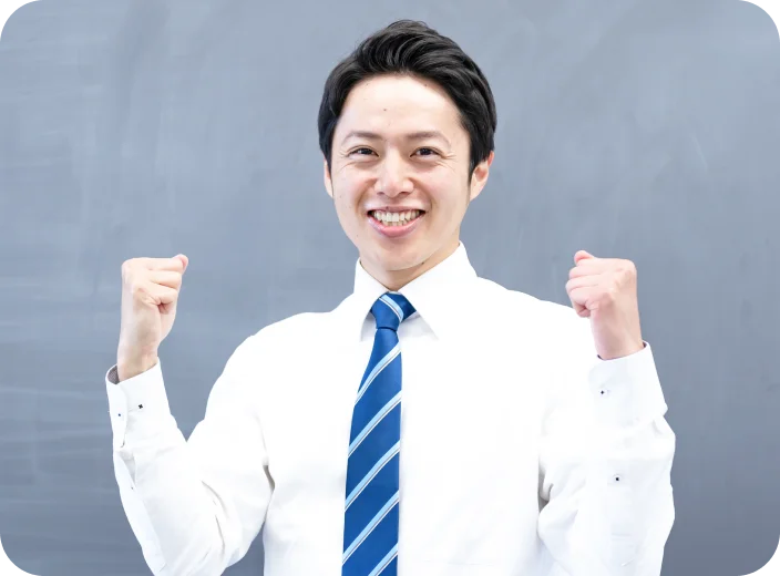 両手でガッツポーズをしている黒髪の男性の画像